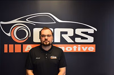 Ahmad, co-owner of CRS Automotive, standing in the Hamilton service centre