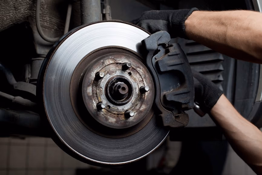 Brake pad close-up on vehicle during inspection at Hamilton auto shop