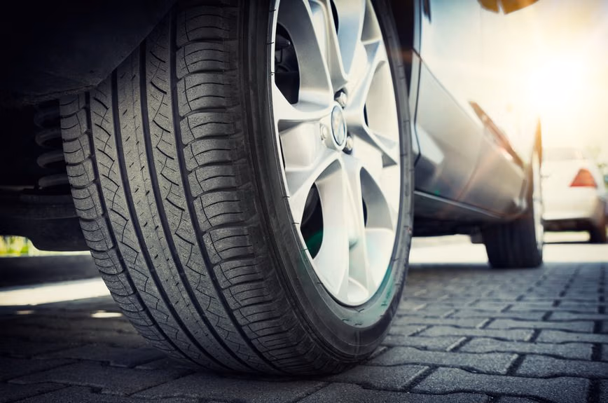 Mechanic checking car tire pressure at auto service centre