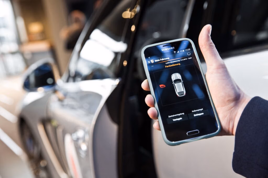 Connected car infotainment touchscreen displaying apps and navigation