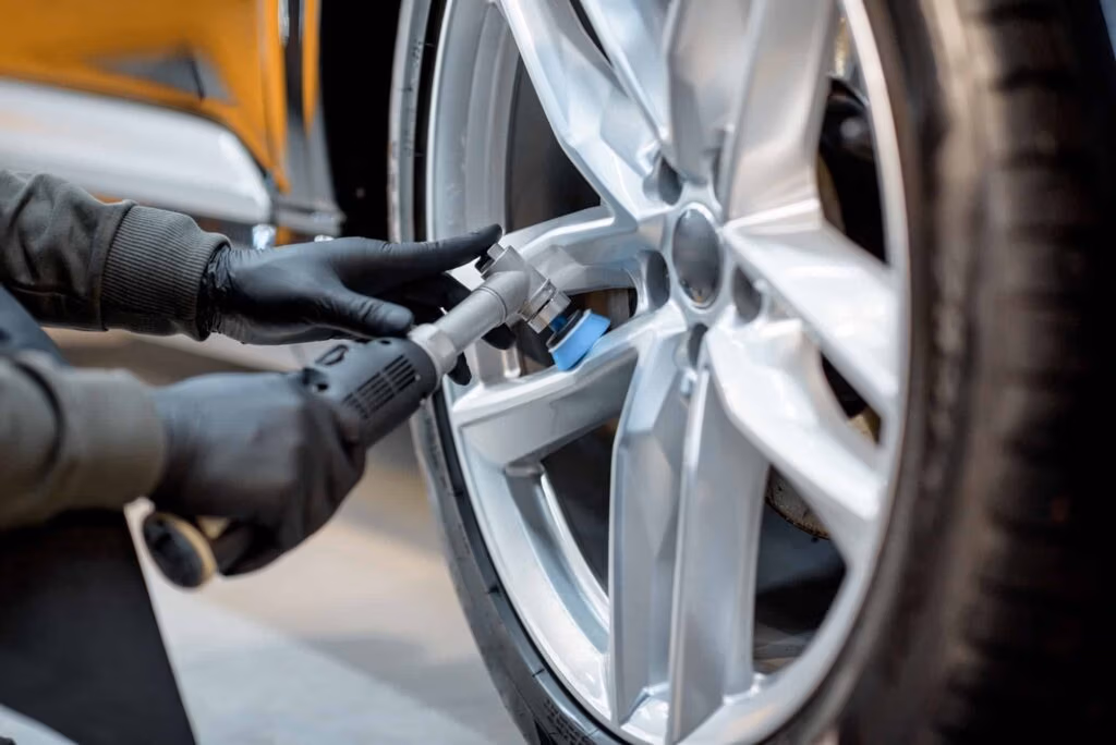 Technician polishing a vehicle disc at an auto service centre in Hamilton
