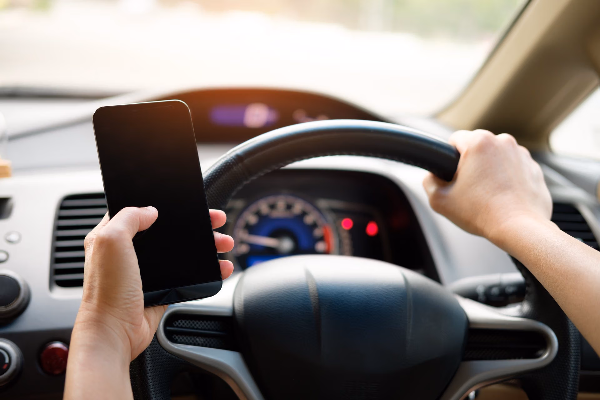 Driver keeping hands off phone while driving to avoid distractions