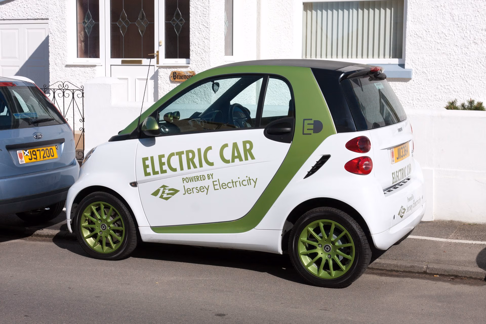 Electric car parked near charging station representing EV ownership costs