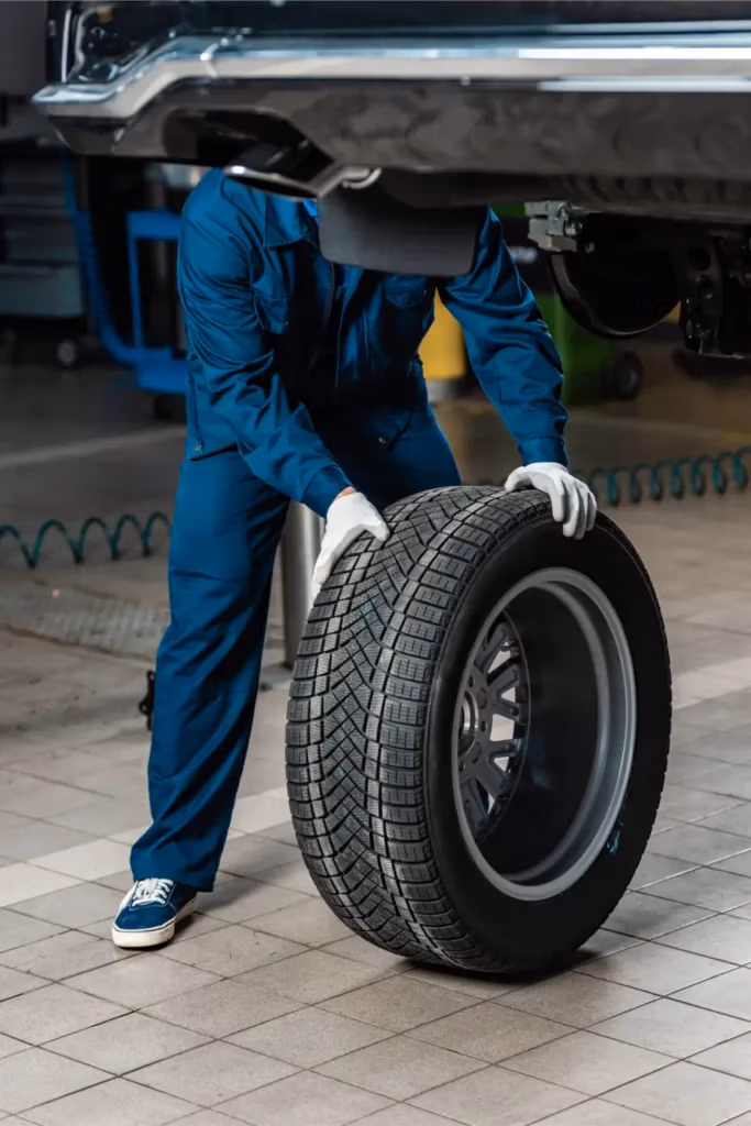 Mechanic inspecting a vehicle wheel at CRS Automotive in Hamilton