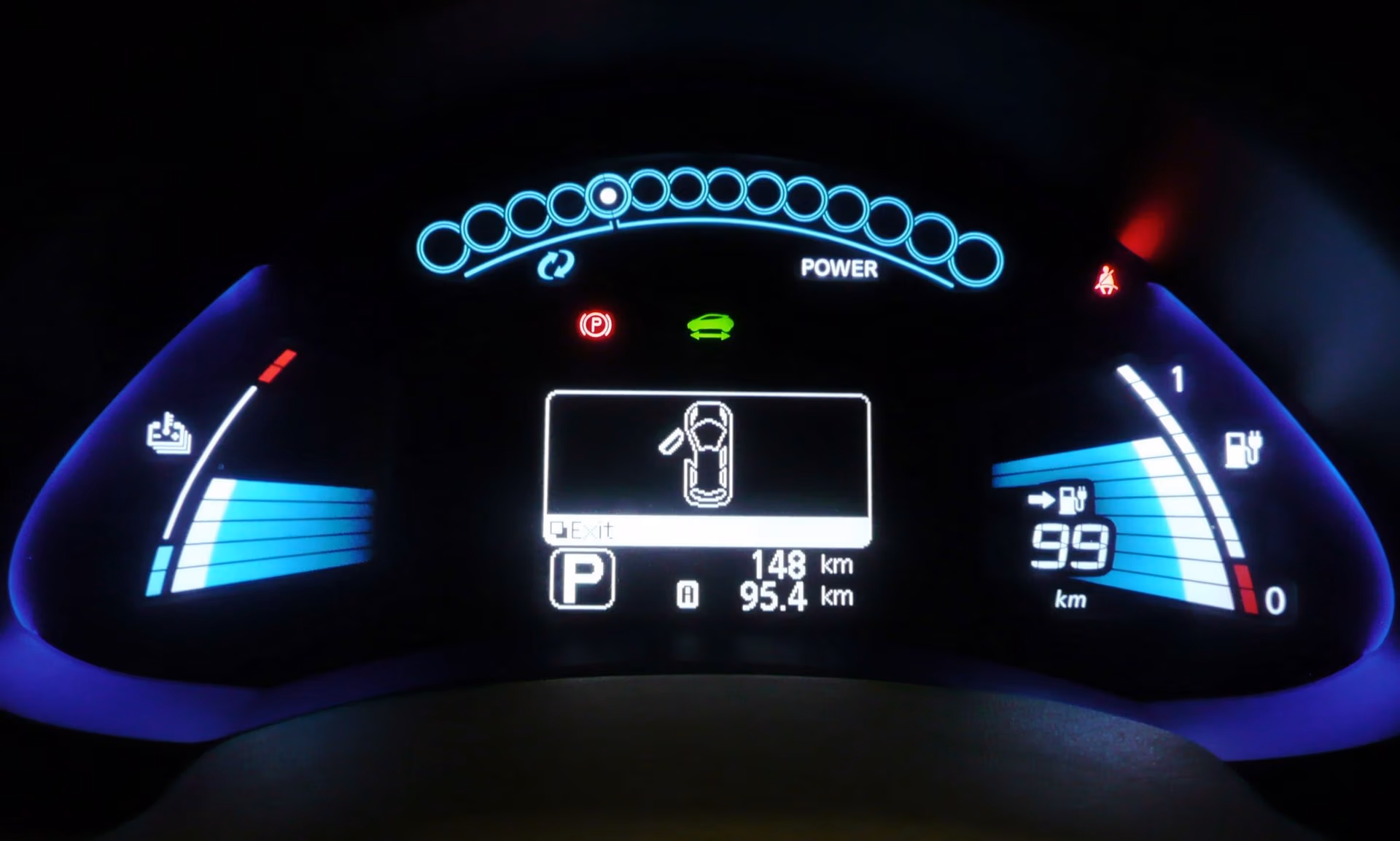 Dashboard display of a Nissan Leaf EV showing instrument cluster and warning icons