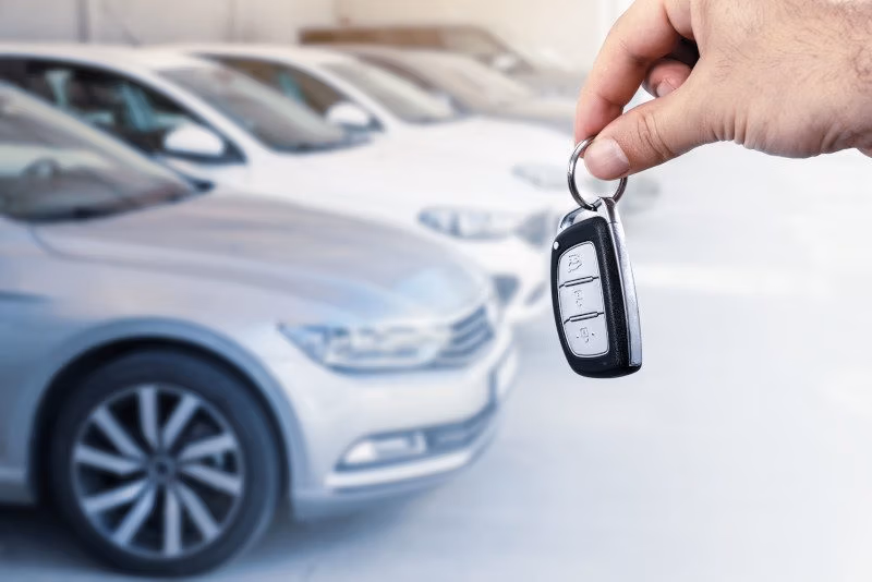 Customer reviewing a used car at CRS Automotive sales shop