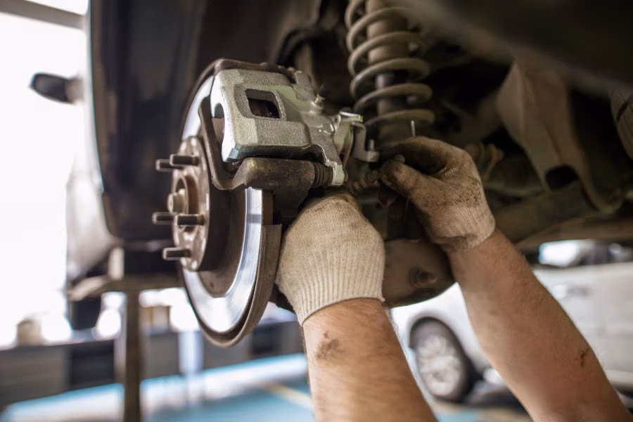 Mechanic inspecting vehicle suspension at CRS Automotive Hamilton