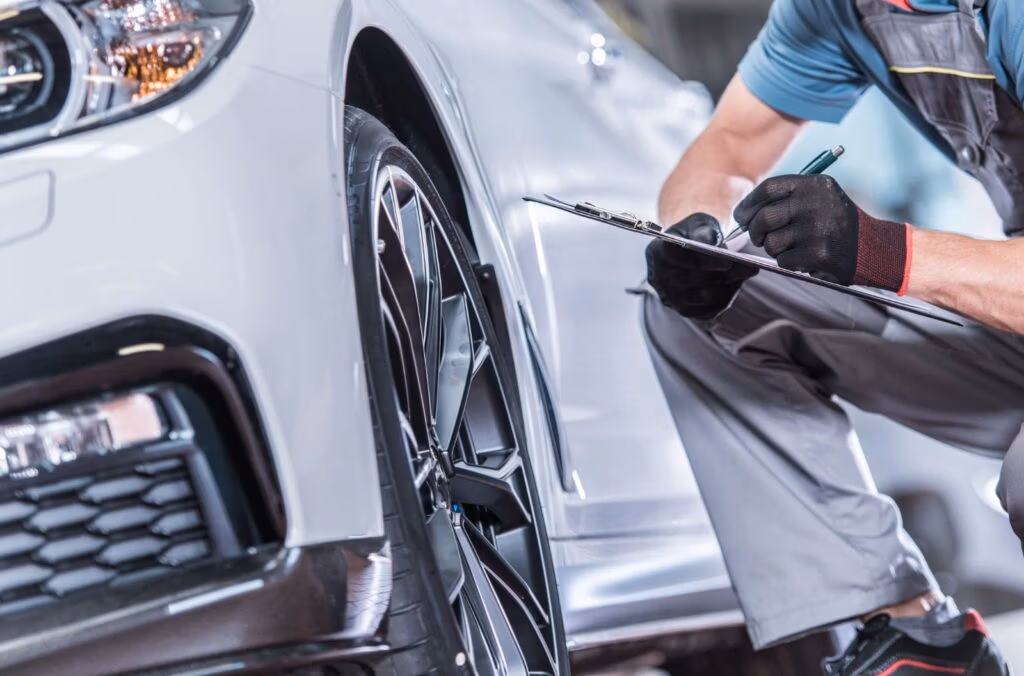 Technician performing vehicle inspection at CRS Automotive Hamilton service centre