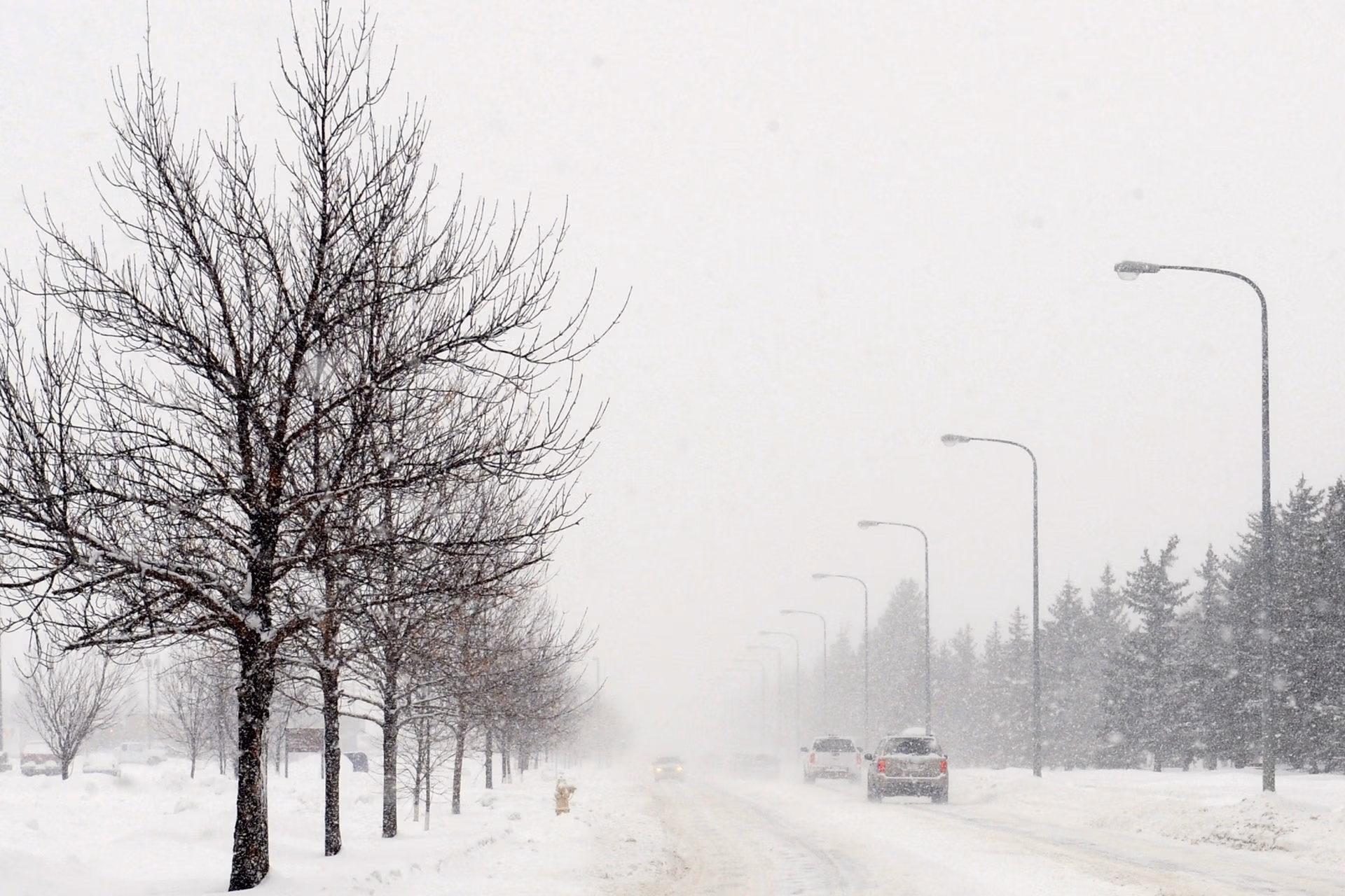 Car parked on a snowy road with winter tires